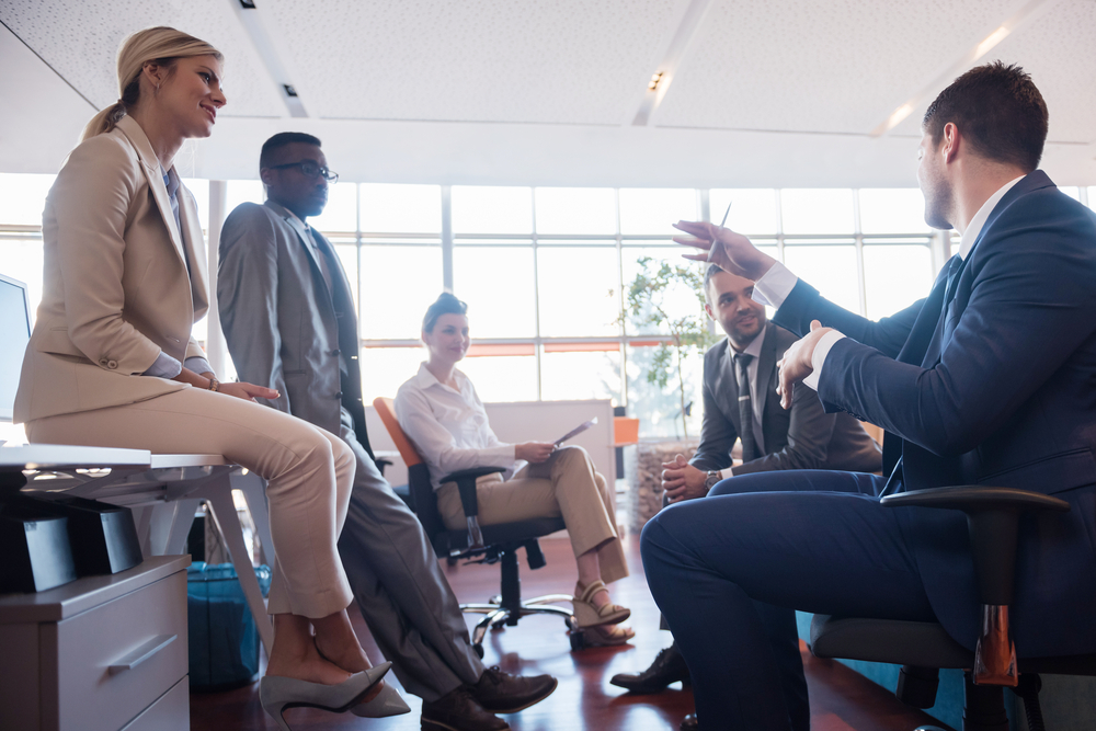 Engaged employees participating in a payroll & human resources meeting